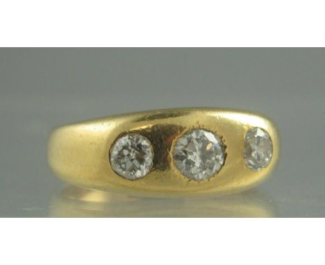 AN 18CT GOLD THEE STONE DIAMOND RING. The three gypsy set diamonds an estimated 0.75cts. Ring size R. Weight 10.8g approx. (B