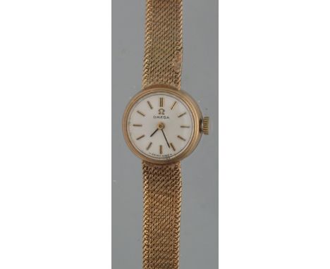 OMEGA 9CT GOLD LADIES BRACELET WRISTWATCH having circular satin face with baton numerals and mesh tapering bracelet strap. Fa