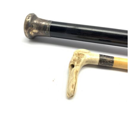 Walking stick with carved horn dogs head handle and an ebonised evening cane with silver top  - Condition Report 