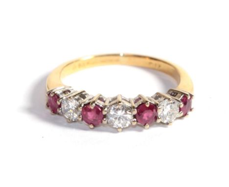 A ruby and diamond seven stone ring, marks rubbed, finger size L1/2.  Gross weight - 3.1 grams