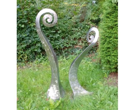 OLIVER STRONG - GARDEN SCULPTURE 'FIDDLE HEADS' the polished stainless steel sculptures of curved shape in the form of a Male