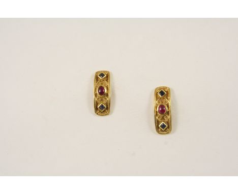 A PAIR OF GOLD, SAPPHIRE AND RUBY EARRINGS each gold earring with embossed rope and ball decoration and mounted with an oval 