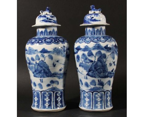 PAIR OF CHINESE BLUE AND WHITE BALUSTER VASES AND COVERS, Kangxi style but later, painted with figures crossing a bridge to a