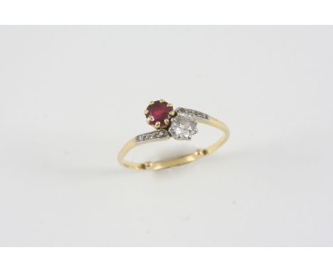 A RUBY AND DIAMOND CROSS-OVER RING the circular-cut ruby is set with an old brilliant-cut diamond, with small diamonds to eac