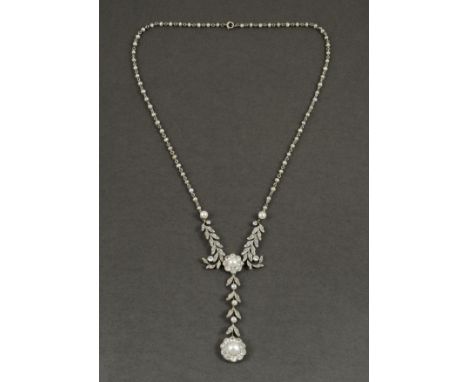 AN EDWARDIAN DIAMOND AND PEARL NECKLACE the foliate scrolling necklace is mounted with rose-cut diamonds centred with an unte