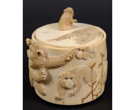 JAPANESE IVORY BOX AND COVER, Meiji, carved with monkeys eating fruit, with a seated monkey finial, carved bug signatures, he