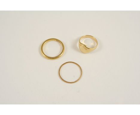 A 22CT. GOLD WEDDING BAND 3.3 grams, size K, together with an 18ct. gold wedding band, 0.6 grams, size N, and an 18ct. gold s