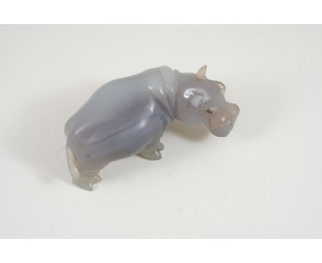A CARVED AGATE FIGURE OF A HIPPOPOTAMUS  realistcally formed, depicted standing, with ruby eyes, 9.5cm. long.