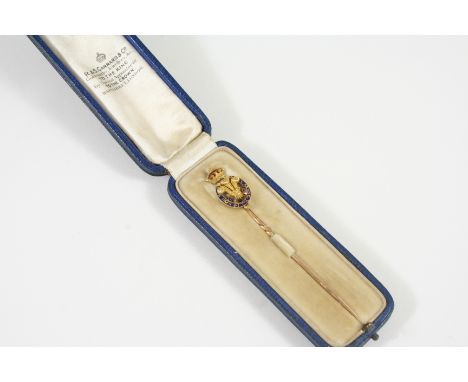 A GOLD AND ENAMEL PRINCE OF WALES FEATHERS STICK PIN  decorated with blue and red enamel.  In a presentation case by R. &amp;