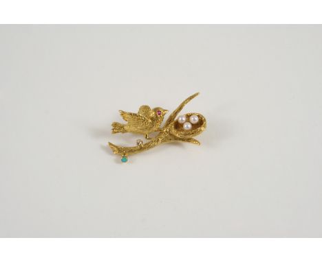 AN 18CT. GOLD AND GEM SET BROOCH formed as a bird on a branch with its nest, set with a circular-cut diamond, a turquoise cab
