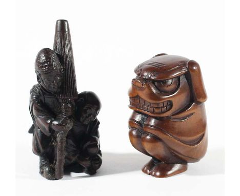 TWO JAPANESE WOODEN NETSUKE, one carved as two men, one carrying a large parasol, the other as a stylised beast, 5cm and smal