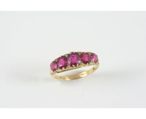 A RUBY AND DIAMOND HALF HOOP RING the five graduated oval-shaped rubies are set with rose-cut diamond highlights, in 18ct. go