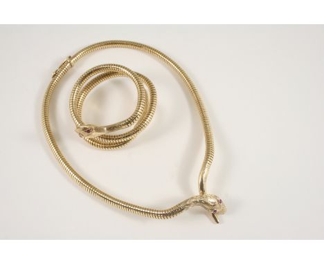 A 9CT. GOLD SNAKE NECKLACE realistically formed, with ruby eyes, 35.5cm. long, 31 grams, together with a matching 9ct. gold b
