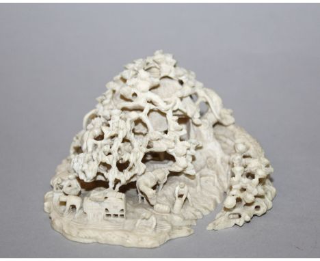 A GOOD SIGNED JAPANESE MEIJI PERIOD PIERCED IVORY OKIMONO, depicting diminutive figures working before a blossom shrouded hut