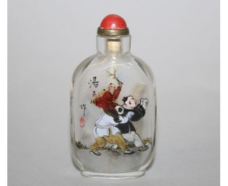 AN EARLY 20TH CENTURY CHINESE INTERIOR PAINTED GLASS SNUFF BOTTLE & STOPPER, painted with playing boys, a column of calligrap