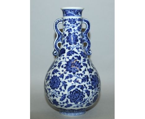 A CHINESE BLUE & WHITE MING STYLE PORCELAIN VASE, the sides of the pear-form body painted with formal scrolling flowerheads, 