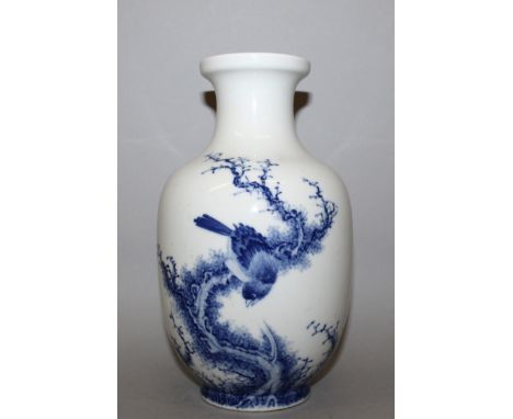 A CHINESE BLUE & WHITE PORCELAIN VASE, the sides decorated with a bird perched on a twisting bough, the base with a seal mark