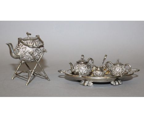 AN UNUSUAL EARLY 20TH CENTURY CHINESE SILVER-METAL MINIATURE TEA SET, weighing approx. 150gm in total, comprising a kettle & 