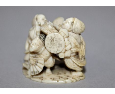 A FINE QUALITY 19TH CENTURY JAPANESE MEIJI PERIOD IVORY NETSUKE OF STREET MUSICIANS BY NAGATSUGU OF TOKYO, two of the figures