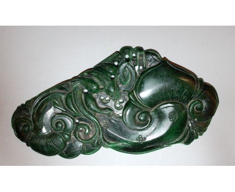 A 19TH/20TH CENTURY CHINESE SPINACH GREEN JADE TABLET, possibly a scroll weight, the flattened shaped form carved in relief w