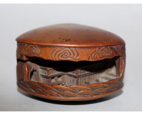 A 19TH CENTURY JAPANESE CARVED WOOD NETSUKE OF THE CLAM’S DREAM BY MITSUNOBU, the interior with diminutive figures before a b
