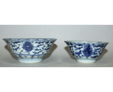 TWO 18TH/19TH CENTURY CHINESE BLUE & WHITE PROVINCIAL PORCELAIN BOWLS, each painted with formal scrolling foliage, each base 