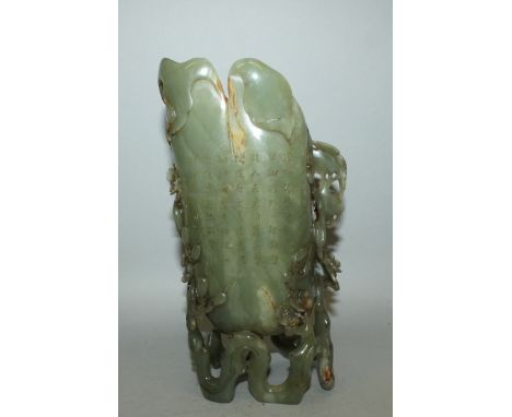 AN UNUSUAL LARGE CHINESE GREEN JADE-LIKE EWER, supported on a meandering pierced prunus branch foot, one side with columns of