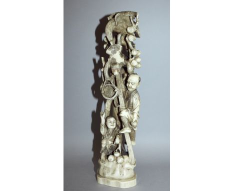 A LARGE SIGNED JAPANESE MEIJI PERIOD CARVED IVORY OKIMONO OF A MONKEY TRAINER, in the company of a boy, the man climbing a po