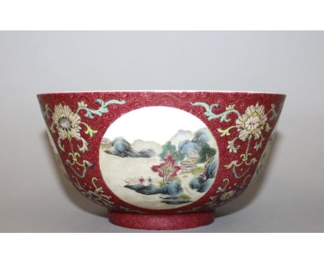 A CHINESE FAMILLE ROSE PORCELAIN MEDALLION BOWL, painted with landscape roundels reserved on a pink sgraffiato scroll ground 