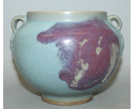 A CHINESE JUN WARE CERAMIC JAR, the shoulders with two lug handles, the sides with an irregular purple splash over a blue gro