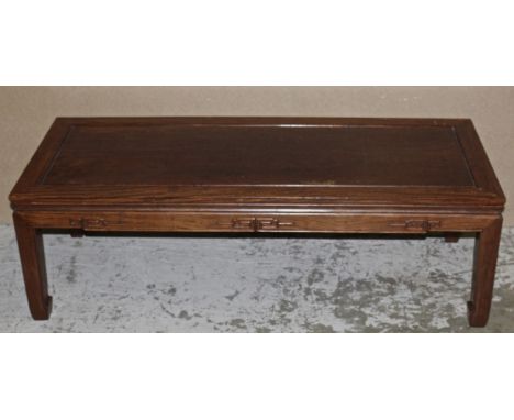 A CHINESE CARVED LIGHT HARDWOOD LOW RECTANGULAR TABLE, the frieze carved in relief with a simple key-fret design, 50in x 20in