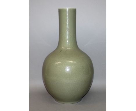 A LARGE 19TH CENTURY CHINESE CELADON BOTTLE VASE, decorated beneath the glaze with a formal design of scroll-stemmed lotus be