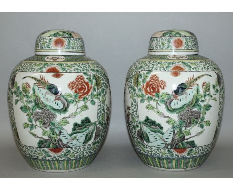 A GOOD MIRROR PAIR OF LATE 19TH CENTURY CHINESE FAMILLE VERTE PORCELAIN JARS & COVERS, each painted with a large panel of a p