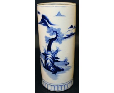 AN EARLY 20TH CENTURY JAPANESE BLUE & WHITE CYLINDRICAL PORCELAIN VASE, the sides painted with a river landscape setting, 11.