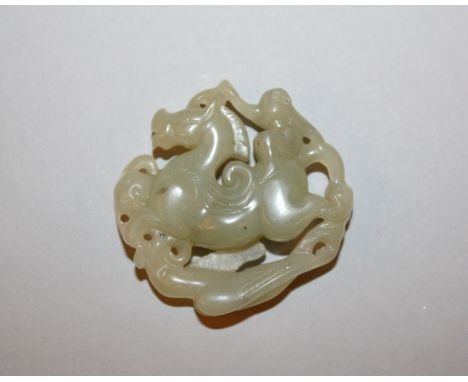 A CHINESE CELADON JADE-LIKE MODEL OF A MONKEY RIDING A HORSE, 2in wide & also 2in high.