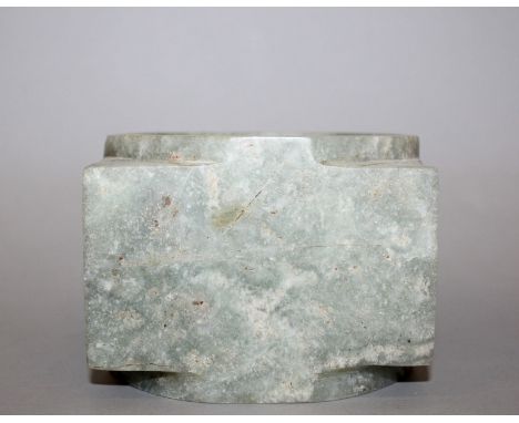 AN EARLY 20TH CENTURY CHINESE JADE-LIKE CONG VASE, the predominantly pale green stone with russet and lighter inclusions, 4.3