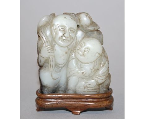 A 19TH CENTURY CHINESE JADE CARVING OF THE HE HE ERXIAN, together with a fixed wood stand, one of the twin boys standing and 