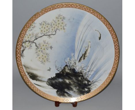 A 19TH CENTURY JAPANESE MEIJI PERIOD FUKAGAWA IMARI CIRCULAR CHARGER painted with carp swimming amongst reeds 40cms diameter.