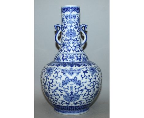 A CHINESE BLUE & WHITE PORCELAIN VASE, of unusual form, the sides painted with bats and dependent tasselled attributes within