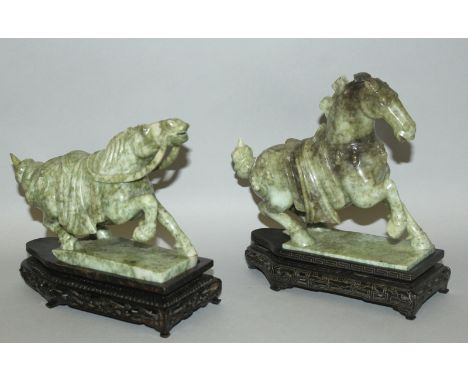 A PAIR OF CHINESE JADE-LIKE MODELS OF HORSES, together with a pair of wire-inlaid wood stands, each rearing backwards on a re