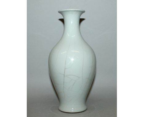 A CHINESE CRACKLEGLAZE CELADON VASE, the sides of the baluster form body with sparse crackling, the base with a Qianlong seal