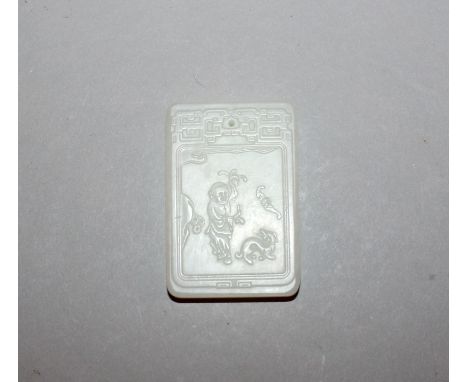 A CHINESE WHITE JADE-LIKE PENDANT, of rectangular form, decorated with a panel of calligraphy and of a boy, 2in x 1.3in.