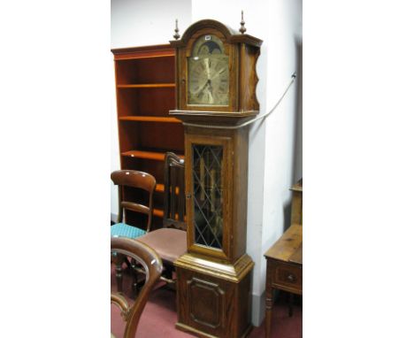 A XX Century Oak West German Musical Longcase Clock, the brass effect moon faced dial inscibe "Fenclocks, Suffolk", the hood 