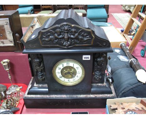 A XIX Century Black Slate Mantel Clock, of architectural form, shaped arched pediment with applied embossed brass plaque depi