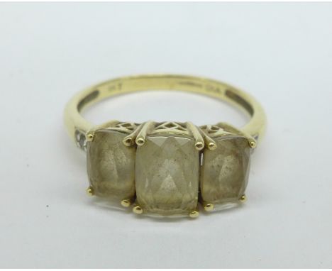 A 9ct gold ring set with three stones and diamond shoulders, 2.3g, O