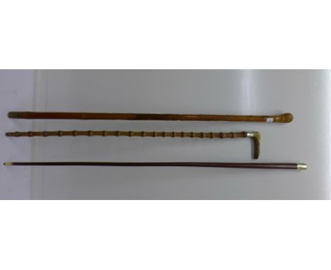 Two canes and a bamboo walking stick with silver collar