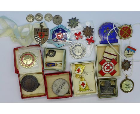 A collection of enamel and other badges including Royal Life Saving Society, ski badges, etc.