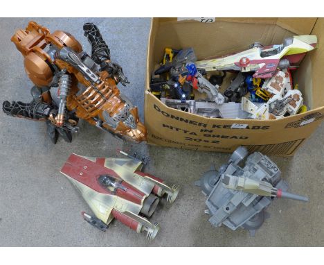 A box of Star Wars and Transformer figures