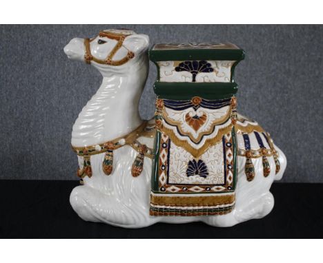 A modern oriental style ceramic Camel garden stool. Hand painted and well detailed. H.49cm. 