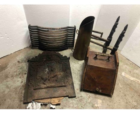 A collection of cast iron fire items, including two coal scuttles, a grate, a back board with knight on horseback and a pair 